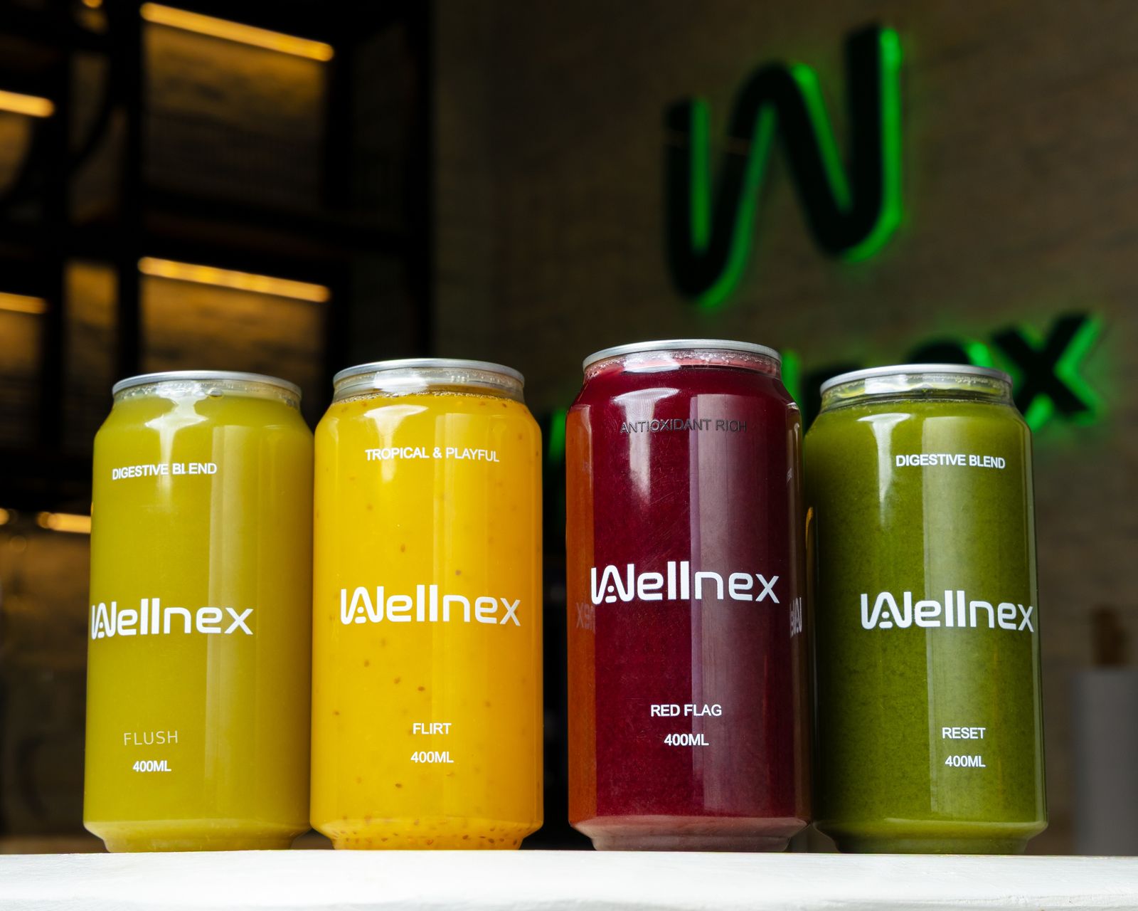 The Wellnex cold-press range in 400ml takeaway cans — Flush, Flirt, Red Flag and Reset