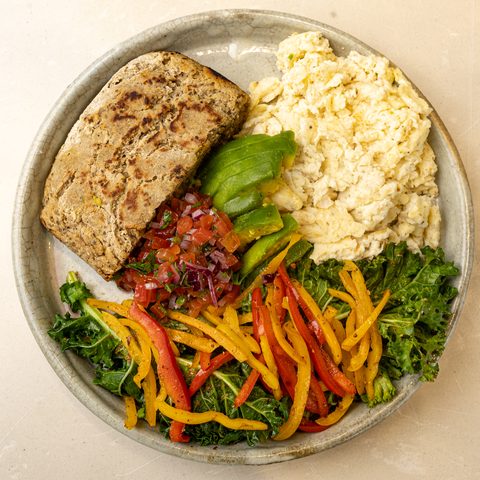 Eggs on Toast — house buckwheat bread, soft scramble, avocado, kale and salsa